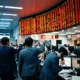 Asian stock exchange display shows red index losses after fresh US strikes inside Iran.