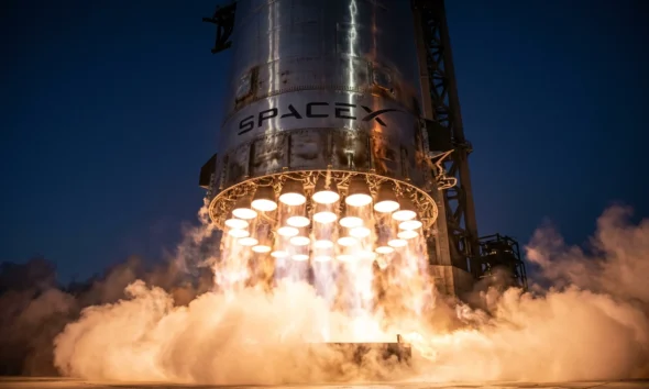 SpaceX Super Heavy booster engines glow during Starship Flight 12 ascent from Starbase.
