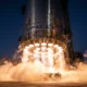 SpaceX Super Heavy booster engines glow during Starship Flight 12 ascent from Starbase.